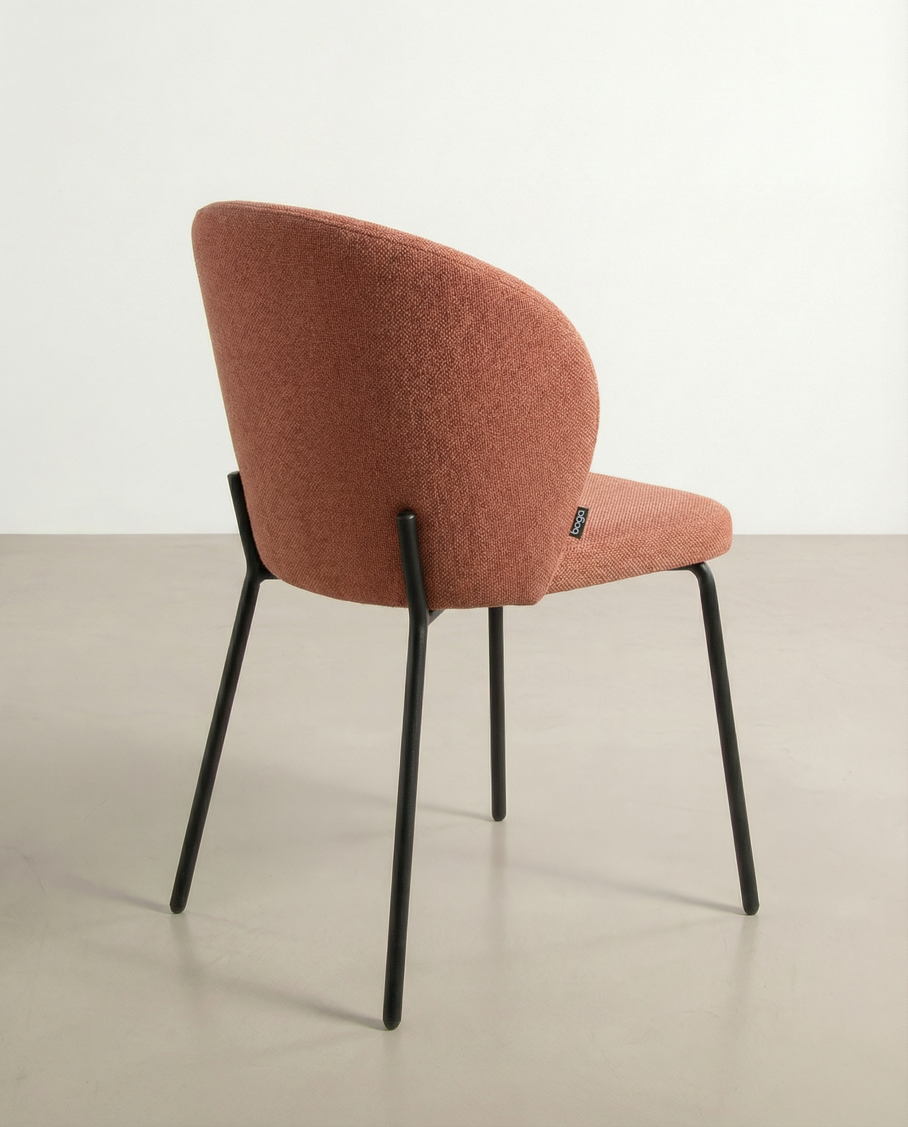 Bergen chair with salmon upholstery and black metal legs