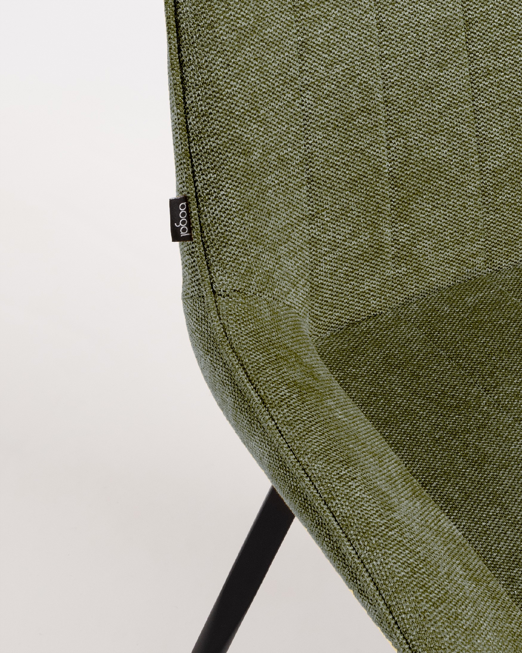 Ankara chair with green upholstery and black legs