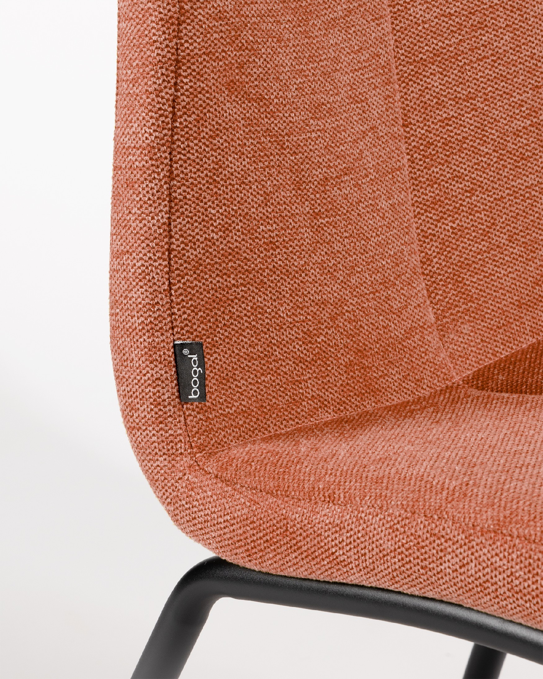 Niza chair with salmon upholstery and black metal legs