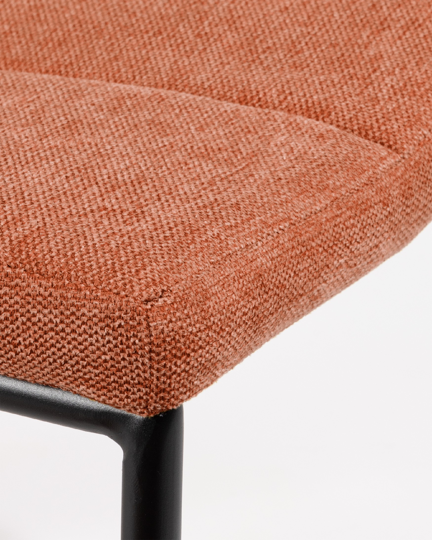 Niza chair with salmon upholstery and black metal legs
