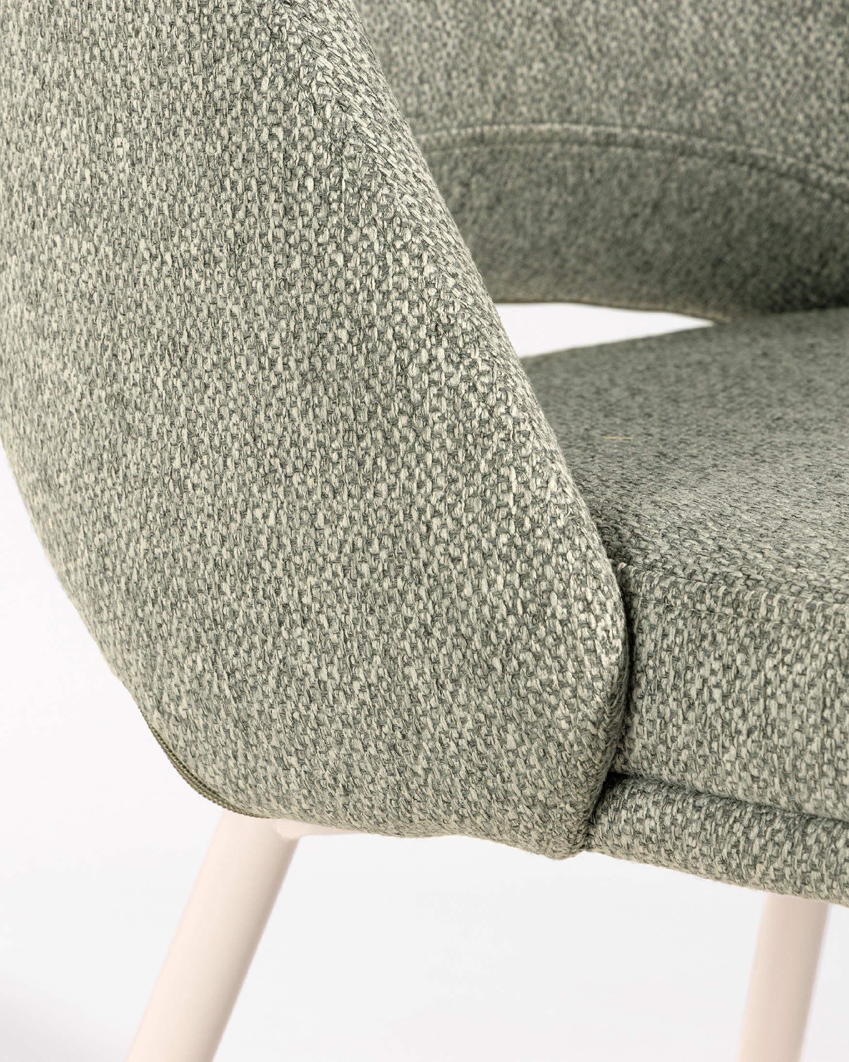 Aman chair with green upholstery and ivory metal legs