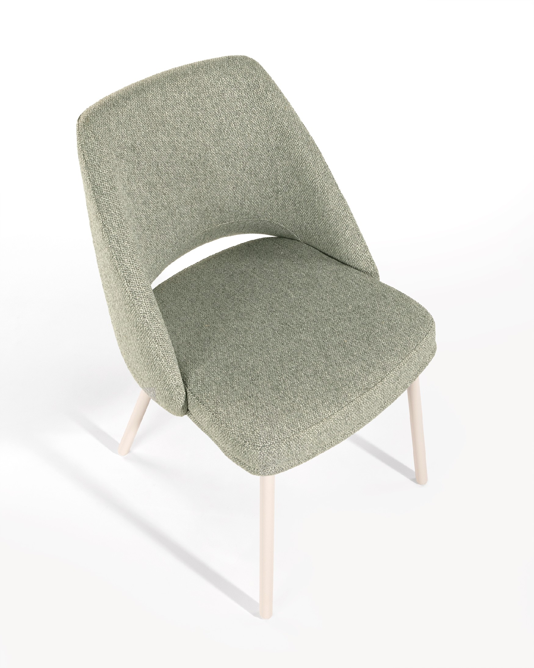 Aman chair with green upholstery and ivory metal legs
