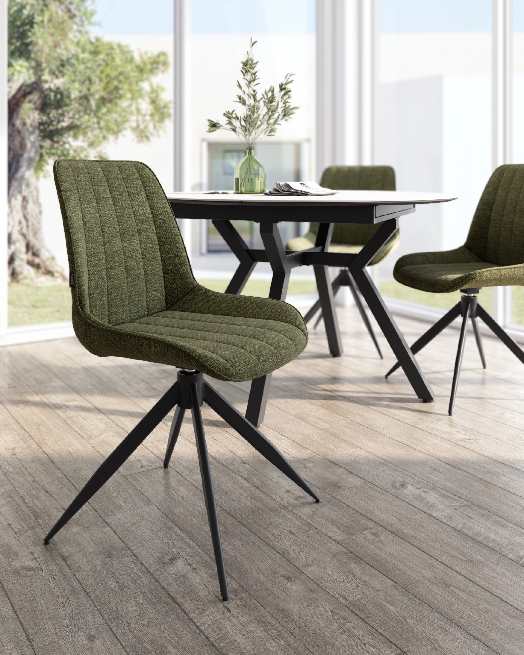 Silla Bursa giratoria 180º con función return, tapizado verde y patas metálicas negras