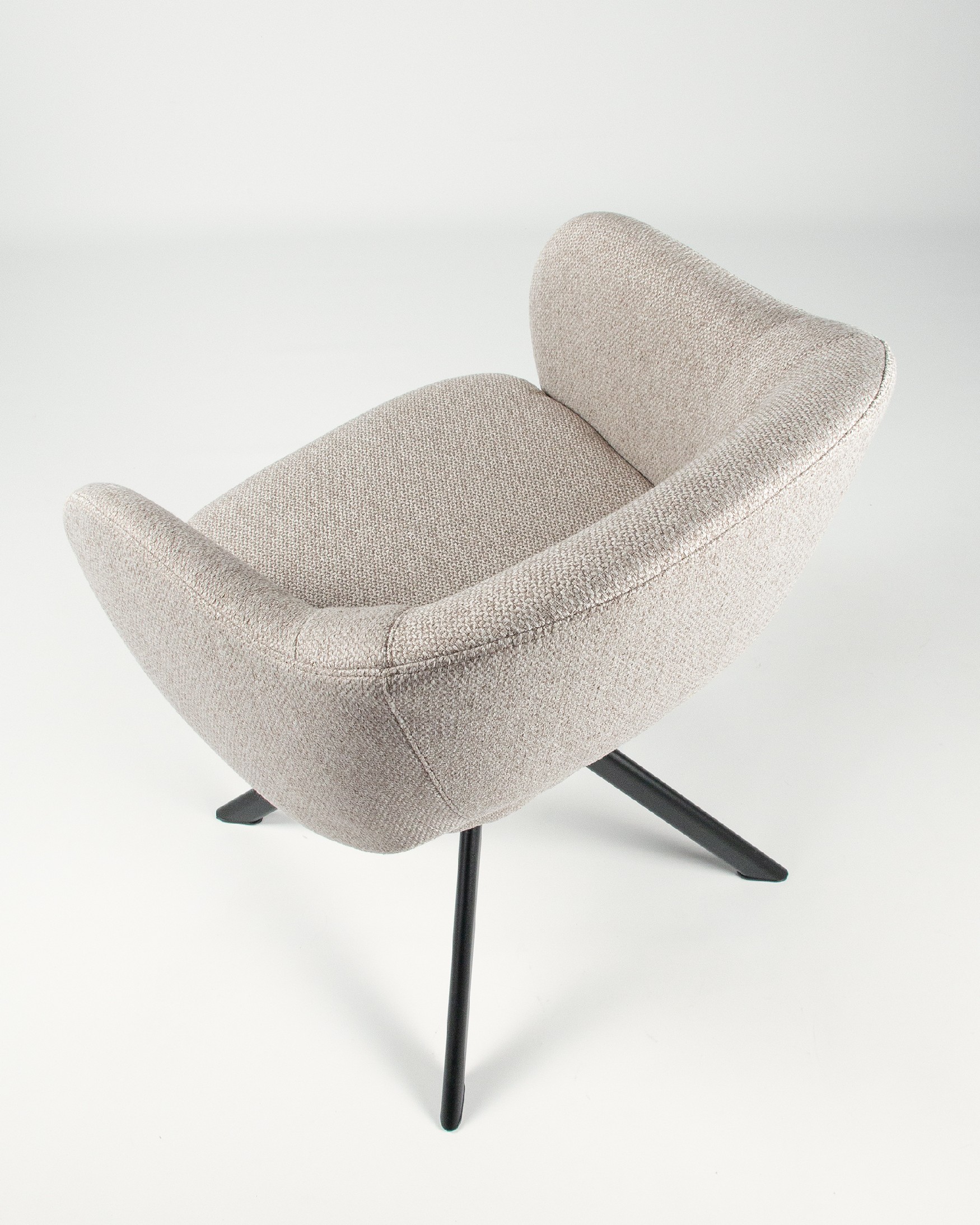 Cork chair with brown upholstery and black metal legs