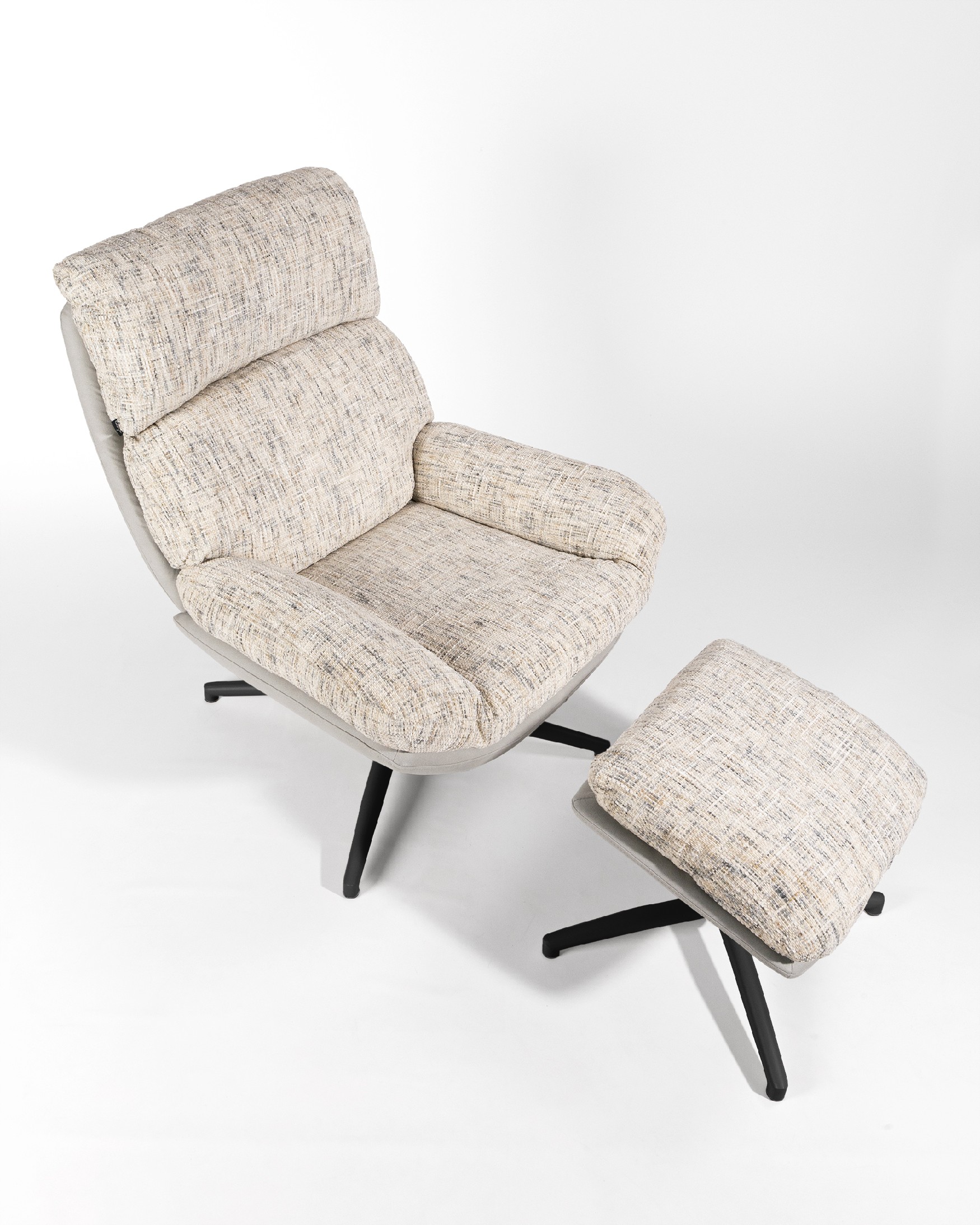 Denia armchair with pearl and cloud upholstery and black metal structure ottoman, 360° swivel rocking.