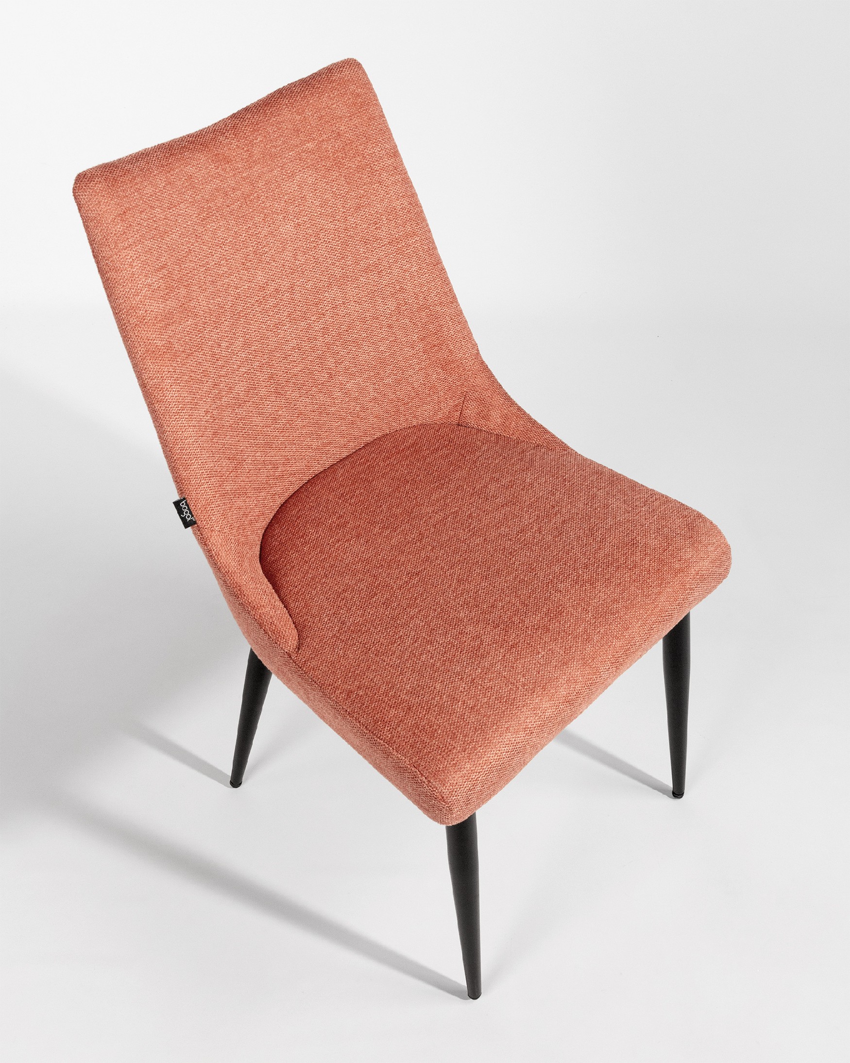 Denver chair with salmon upholstery and black metal legs