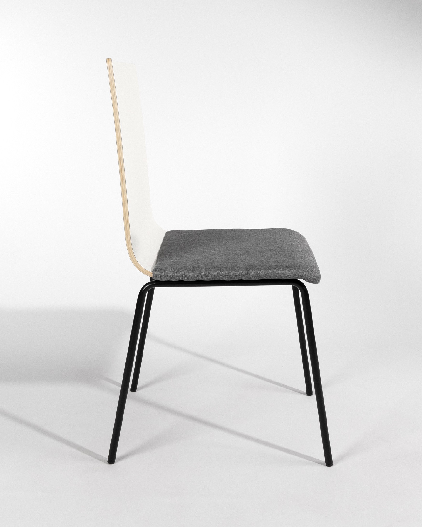 Silla Dubai con tapizado gris, respaldo soul blanco y patas metálicas negras