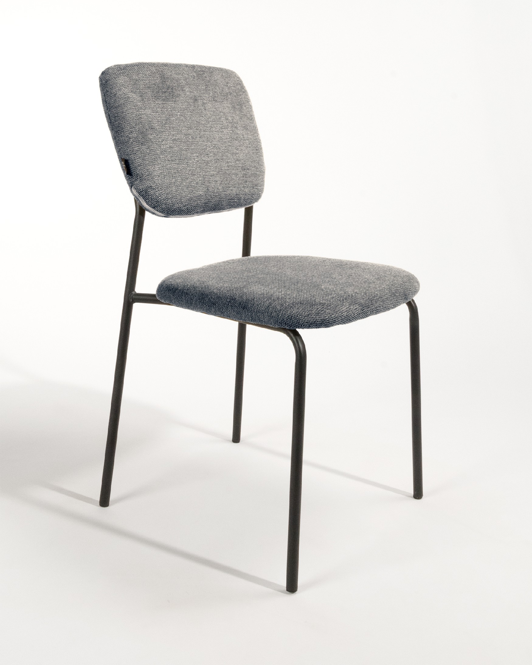Kobe chair with gray upholstery and black metal legs