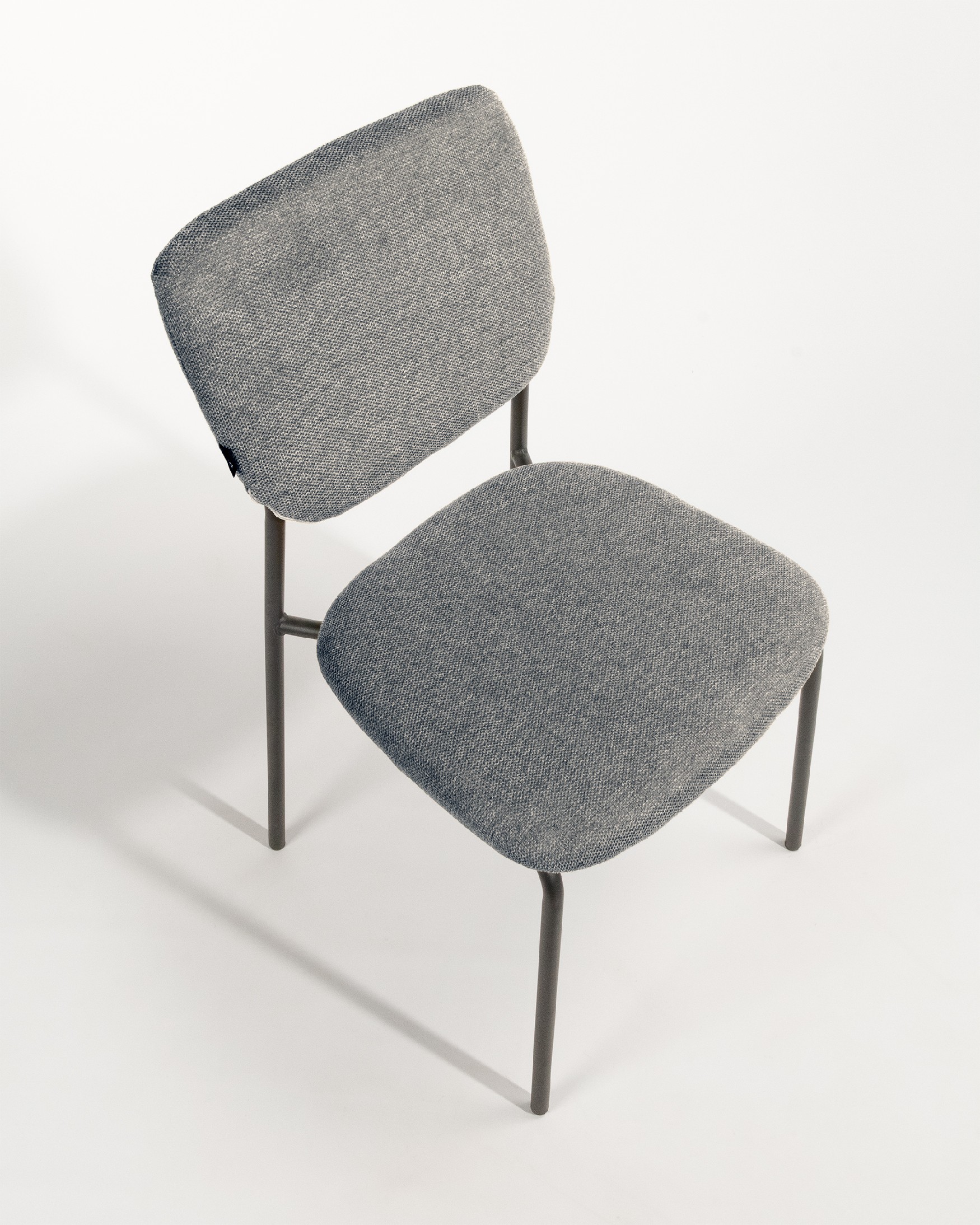 Kobe chair with gray upholstery and black metal legs