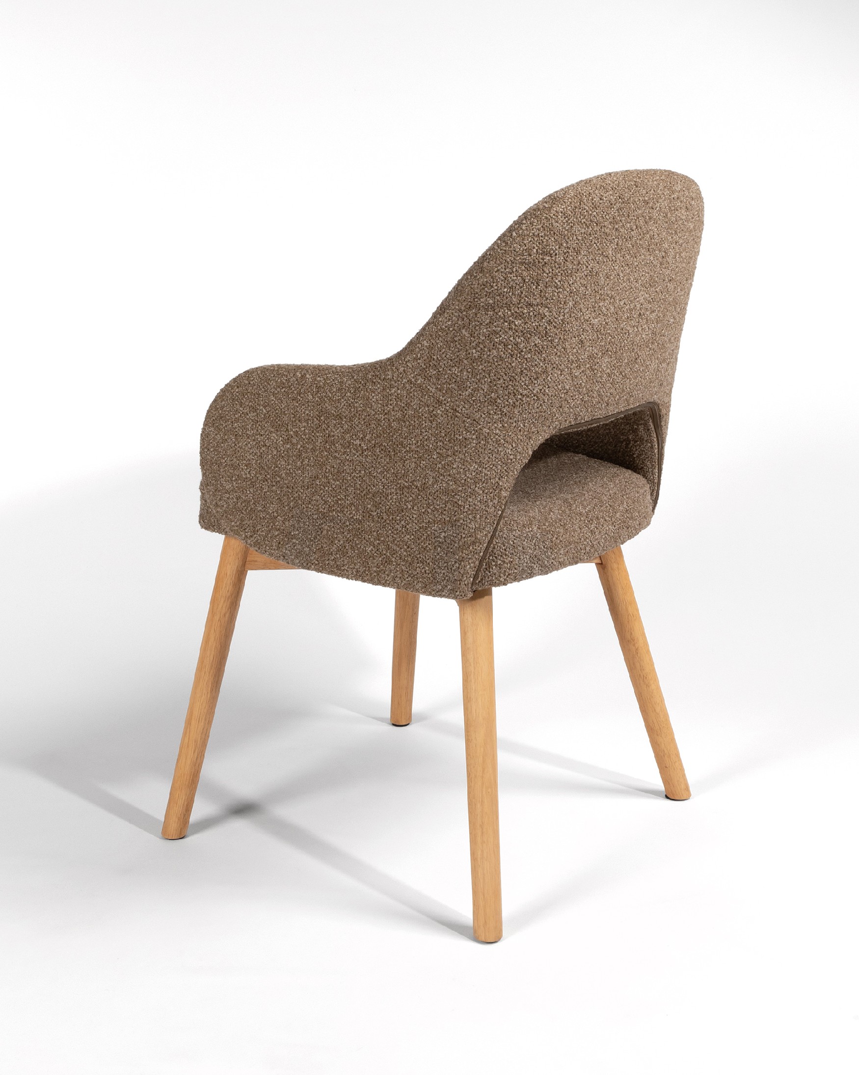 Ona chair with brown upholstery and oak legs