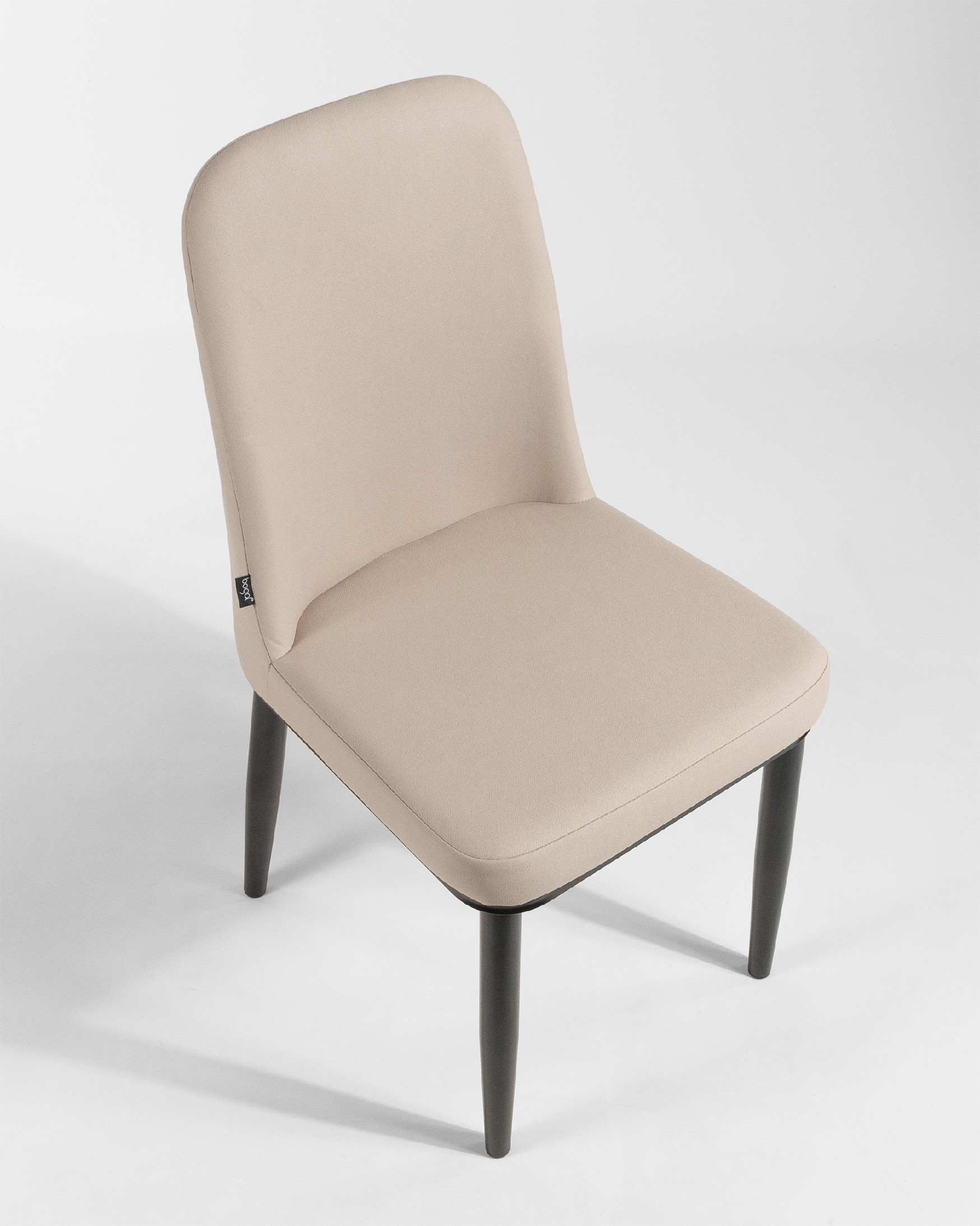 Oslo chair with beige upholstery and black legs