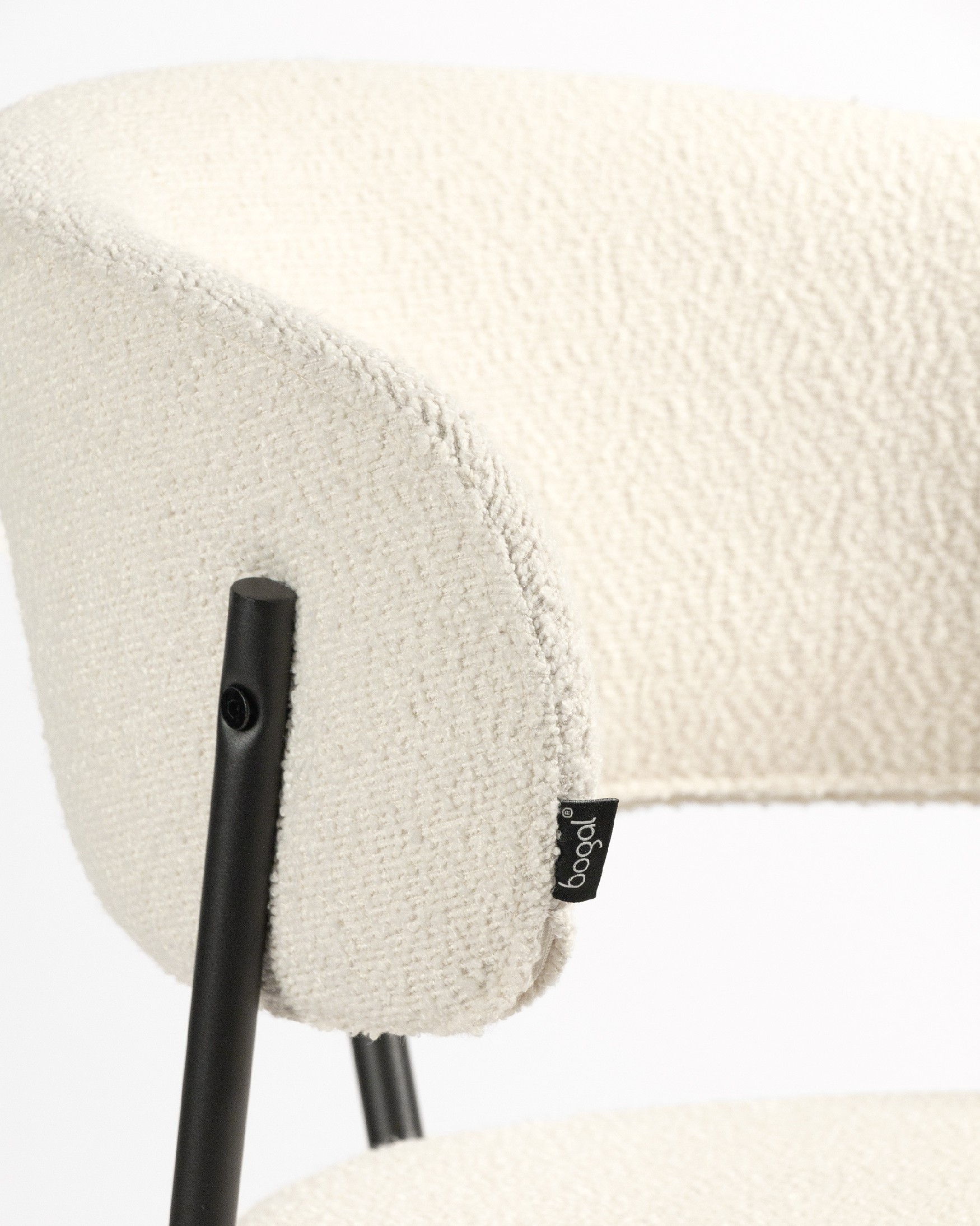 Quebec chair with off-white upholstery and black metal legs