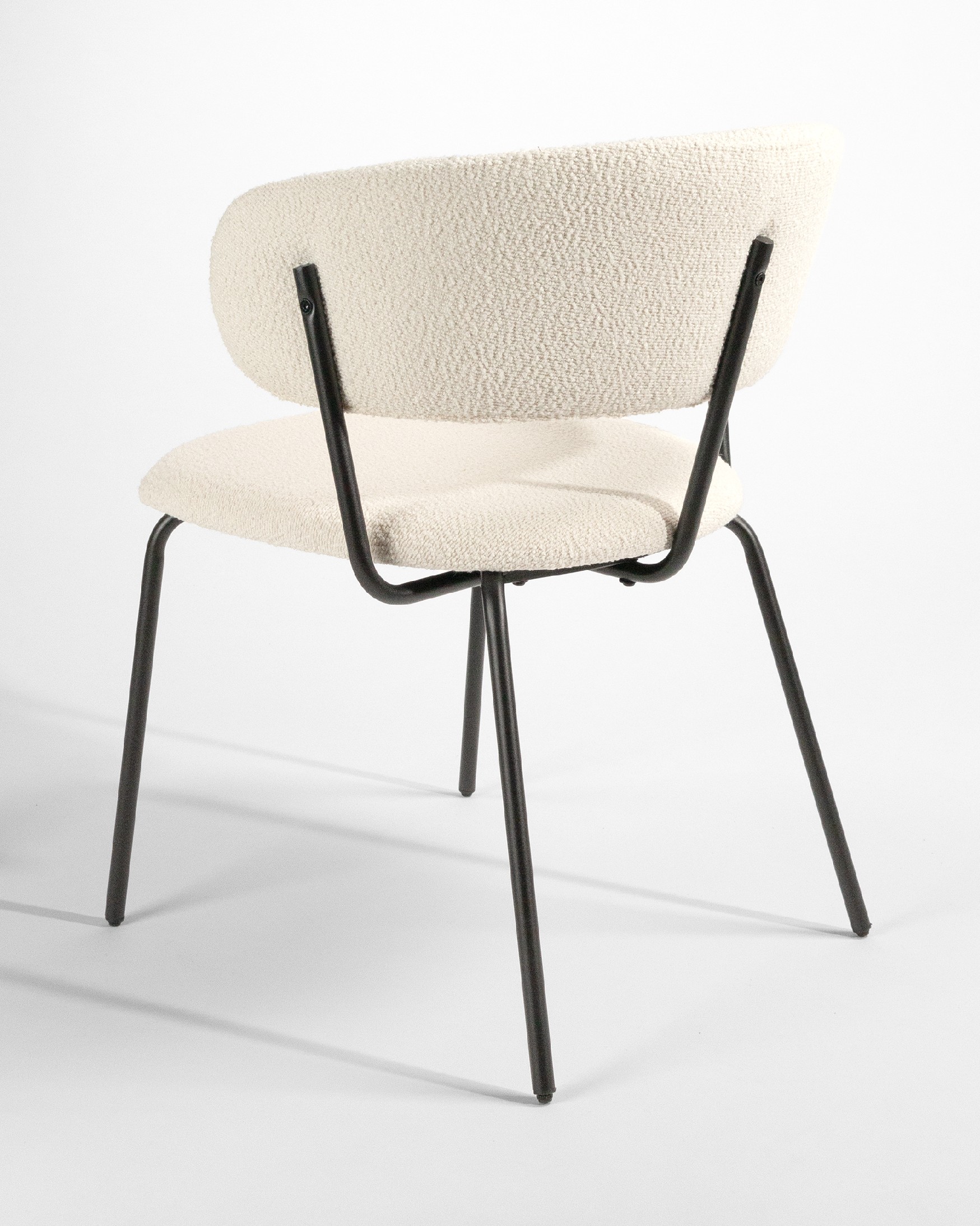 Quebec chair with off-white upholstery and black metal legs