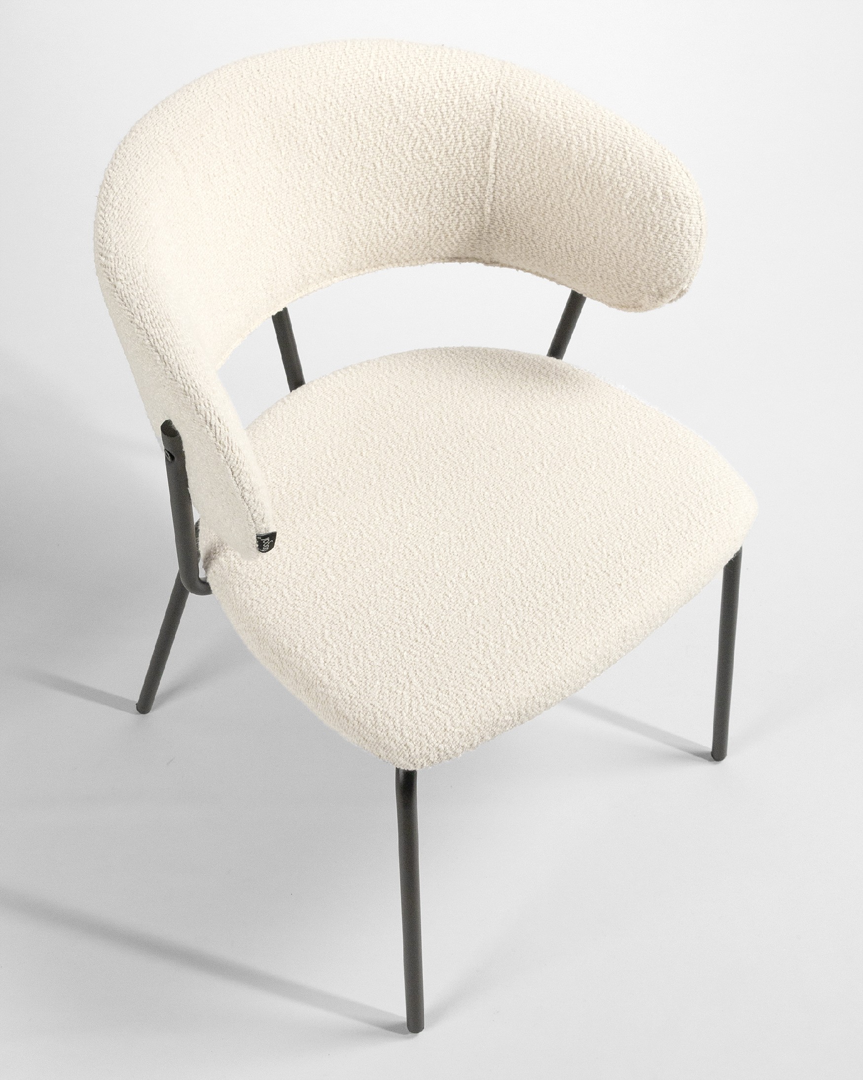 Quebec chair with off-white upholstery and black metal legs