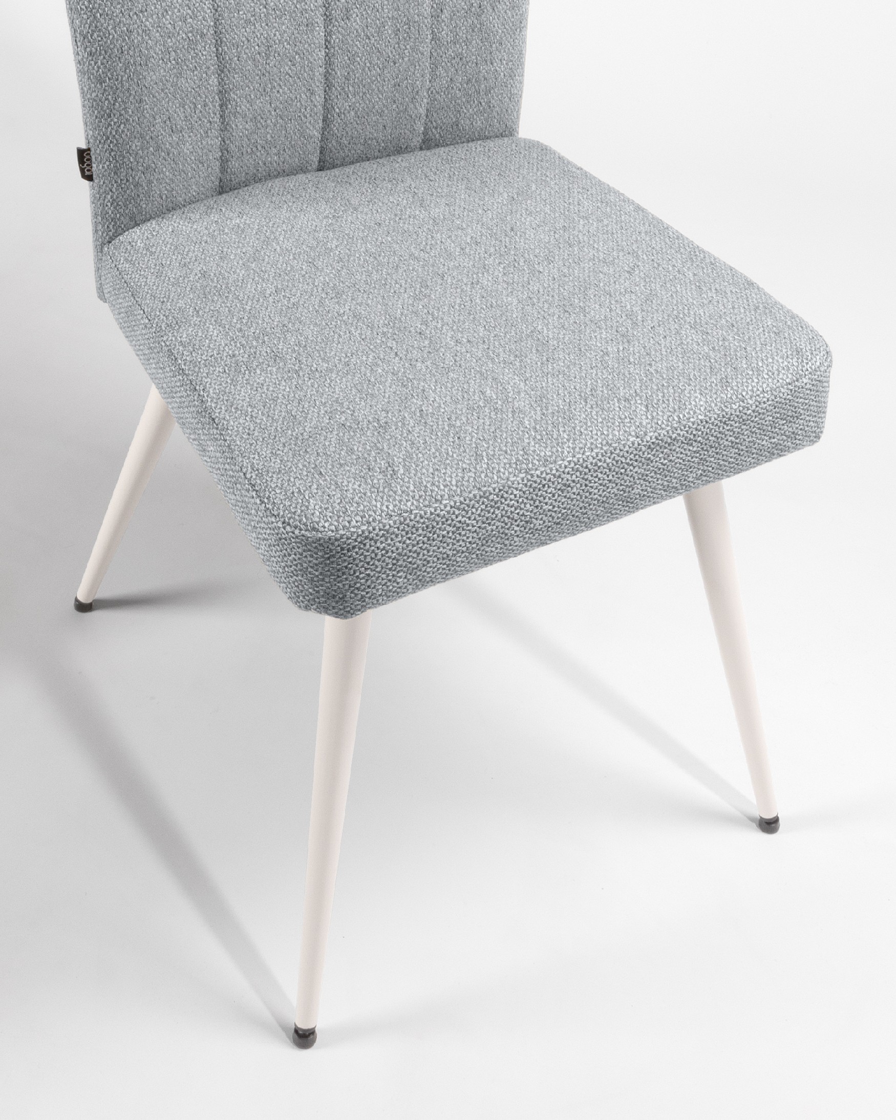 Tucson chair with gray upholstery and ivory metal legs
