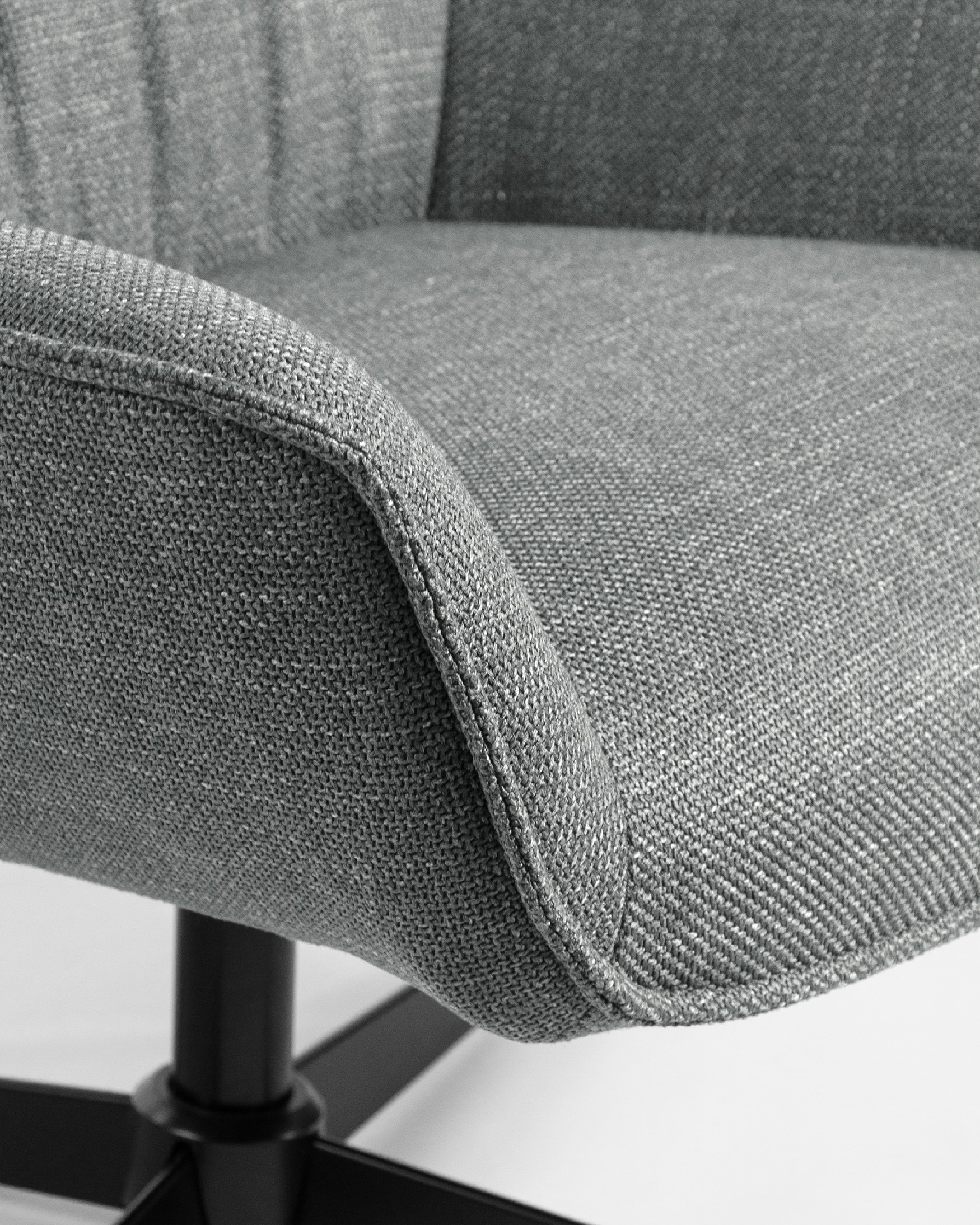 Tulip swivel armchair with gray upholstery and black metal legs.
