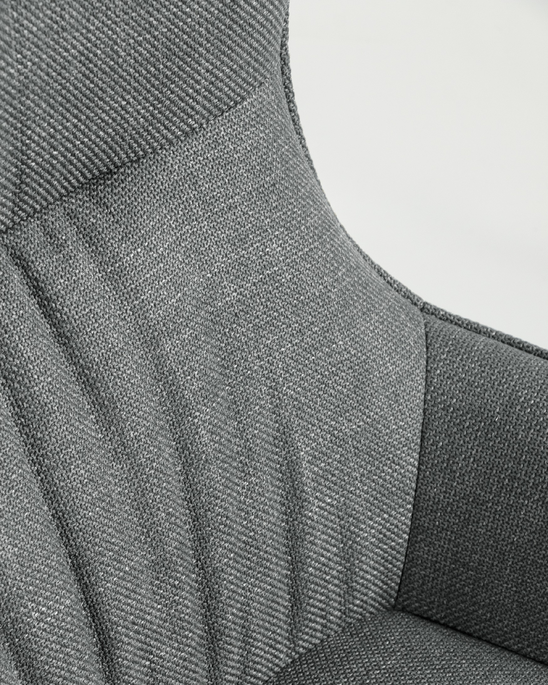 Tulip swivel armchair with gray upholstery and black metal legs.