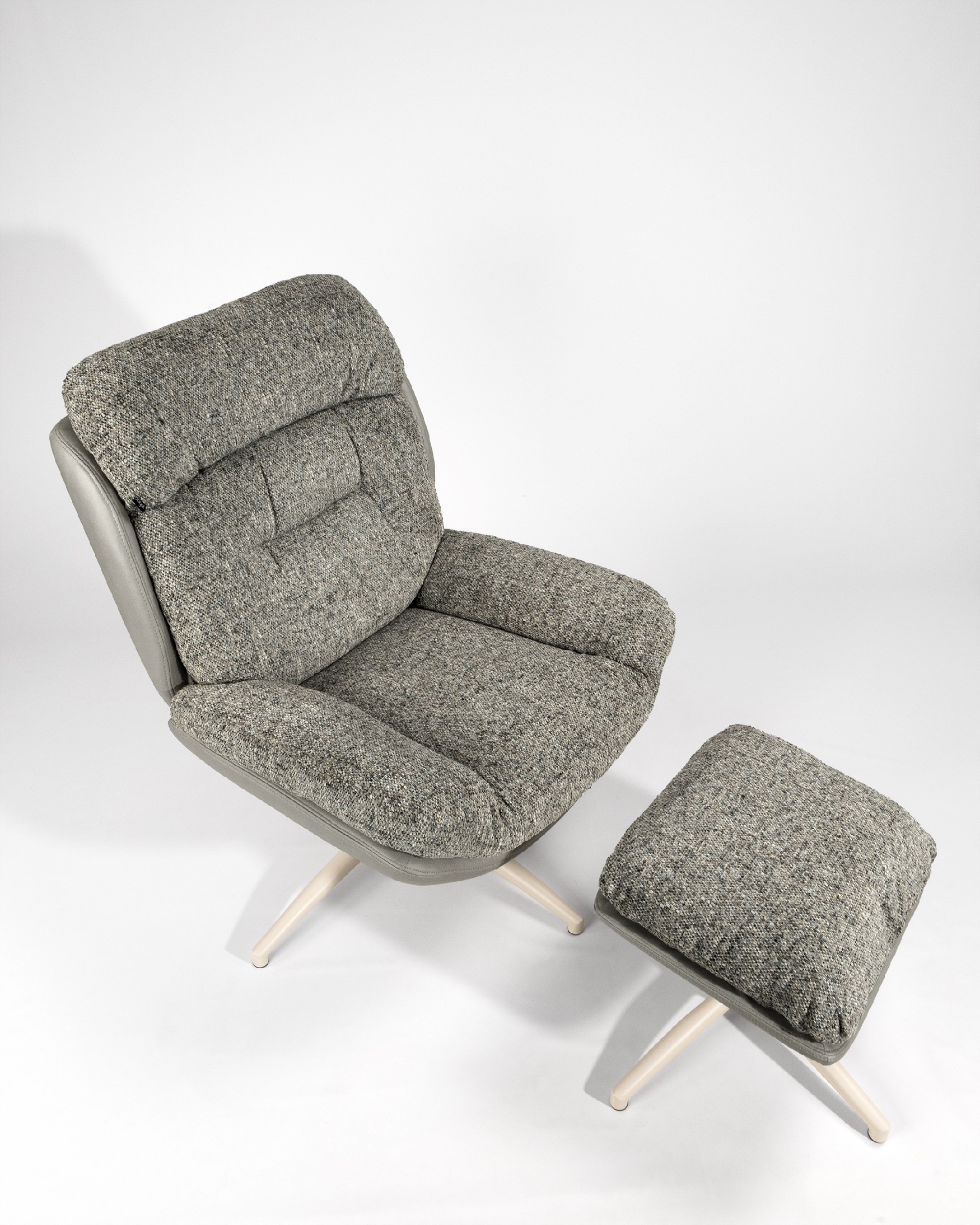 Velina armchair with gray and storm upholstery with ivory metal structure ottoman, 360° swivel rocking.